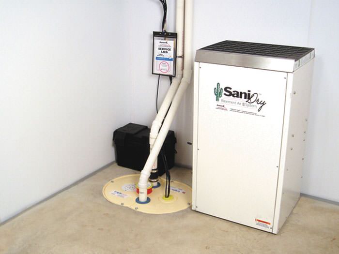 An installed crawl space dehumidifier with a self-draining design